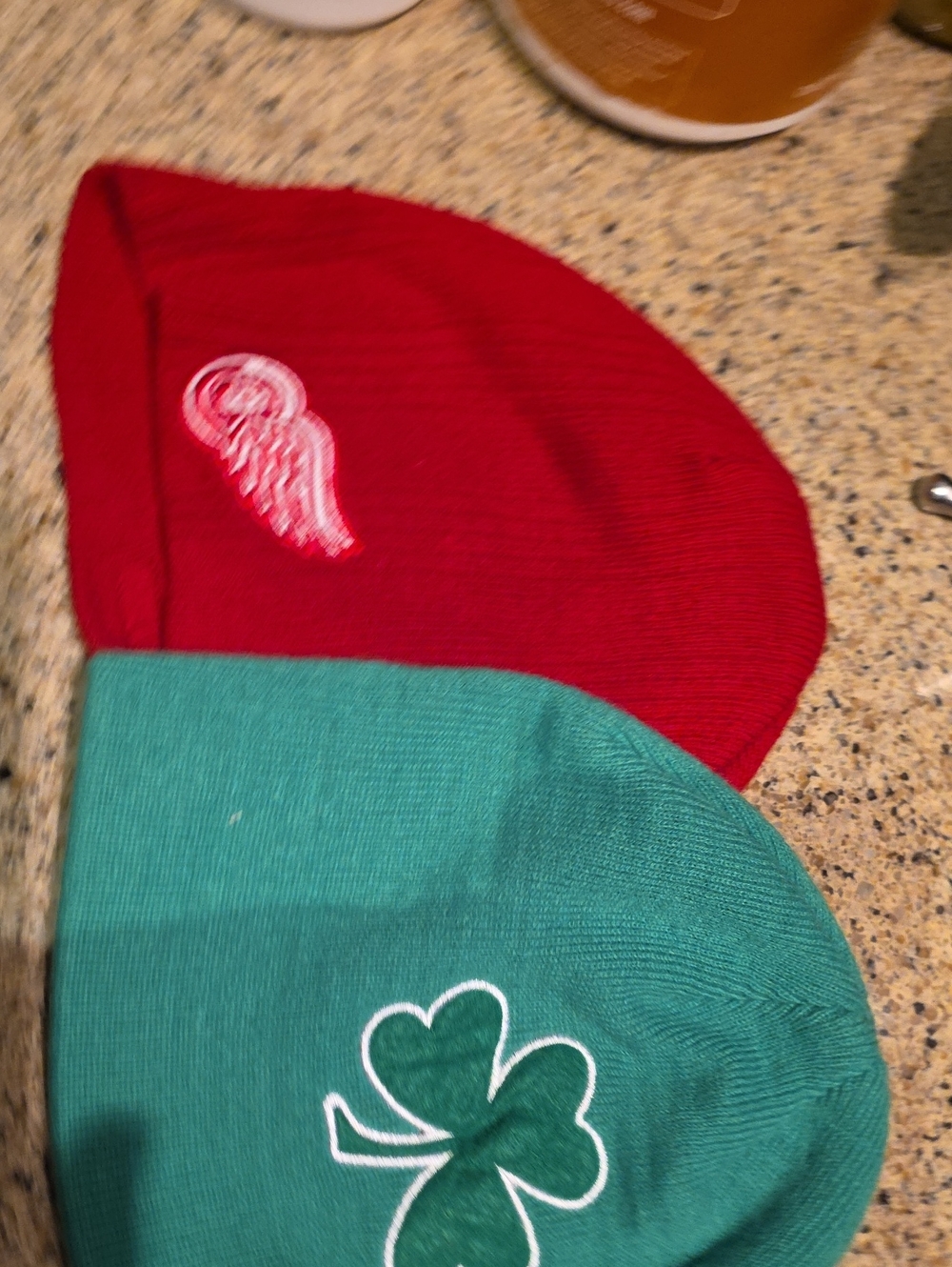 Red and Green Knit Beanie Hats with Embroidered Motifs